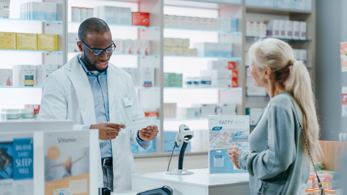 Pharmacy Drugstore Checkout Counter: Black Male Pharmacist Expla